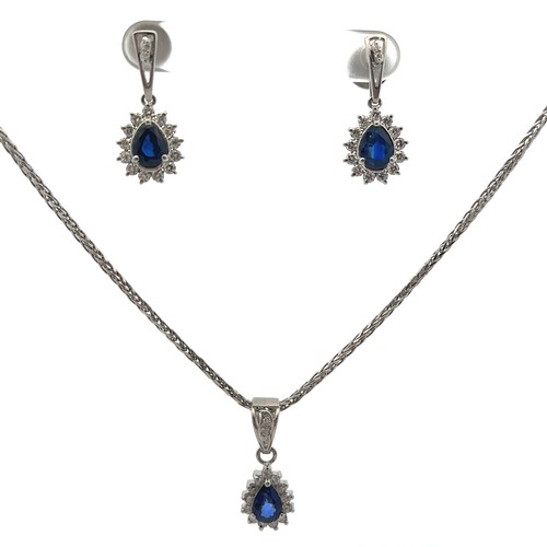 30 - A sapphire and diamond necklace and earrings set. The necklace with a central pear shaped sapphire s... 