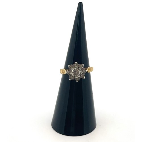 31 - An 18ct yellow gold and diamond flower ring, size I. Central diamond of approx 0.2ct is illusion set... 