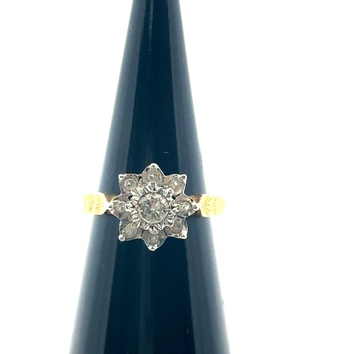 31 - An 18ct yellow gold and diamond flower ring, size I. Central diamond of approx 0.2ct is illusion set... 