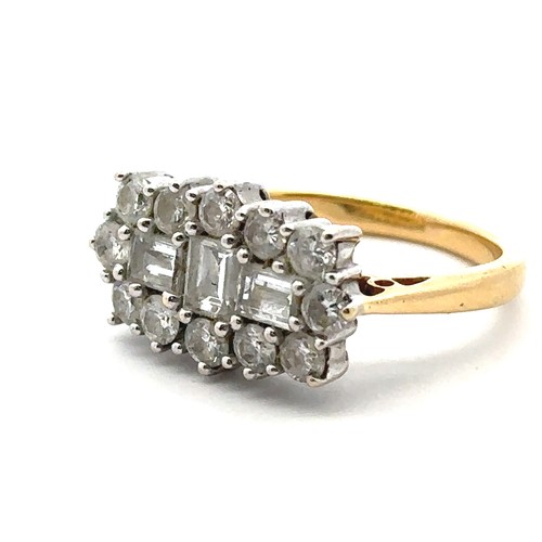 34 - An 18ct and diamond cluster ring - set with three baguette cut diamonds surrounded by 12 round brill... 