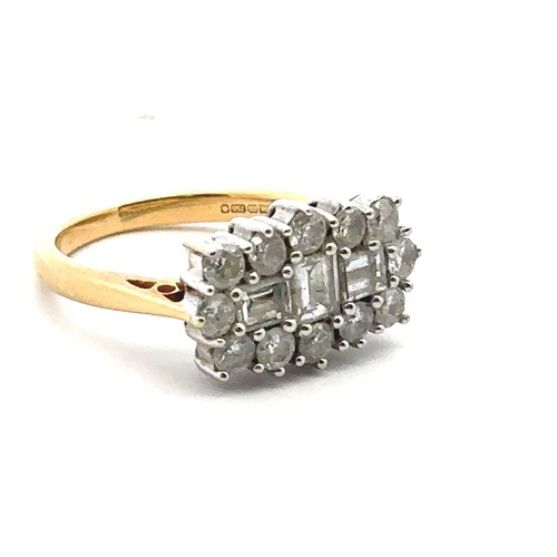 34 - An 18ct and diamond cluster ring - set with three baguette cut diamonds surrounded by 12 round brill... 