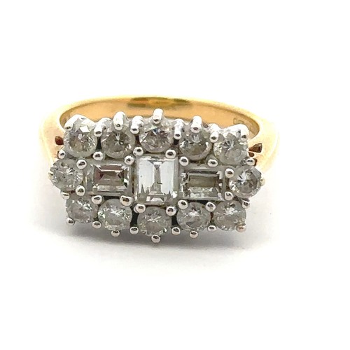 34 - An 18ct and diamond cluster ring - set with three baguette cut diamonds surrounded by 12 round brill... 