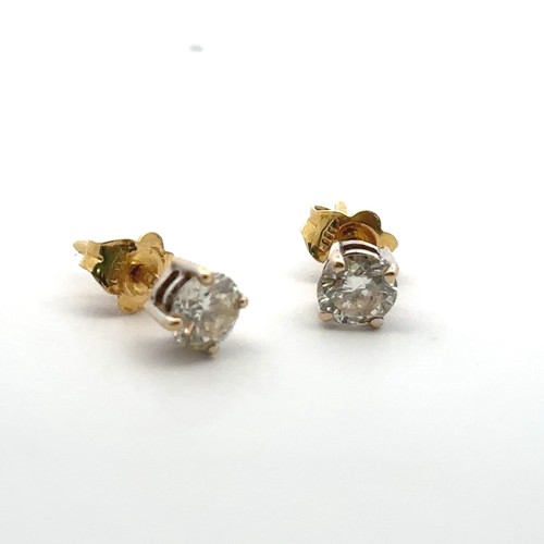 62 - A pair of 18ct gold and diamond earrings. Total diamond weight approx 1ct. Weight 1.58g.