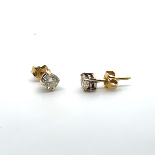 62 - A pair of 18ct gold and diamond earrings. Total diamond weight approx 1ct. Weight 1.58g.