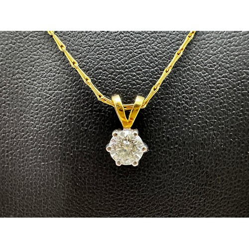 63 - A diamond pendant set in 18ct yellow gold with an 18ct yellow gold 16