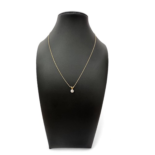 63 - A diamond pendant set in 18ct yellow gold with an 18ct yellow gold 16