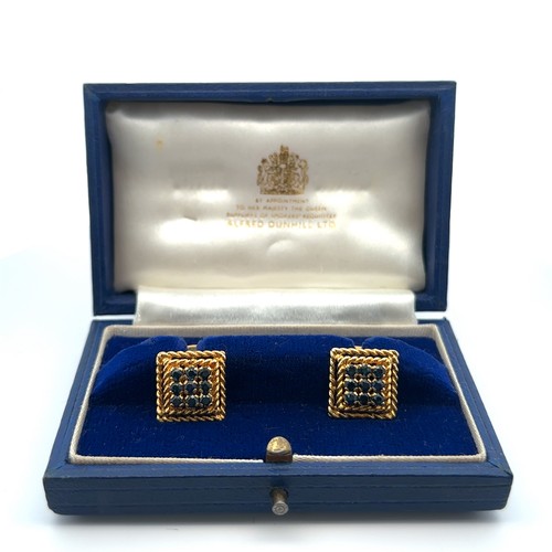 17 - A pair of 18ct yellow gold cufflinks with rope twist designed mount and set with nine round sapphire... 