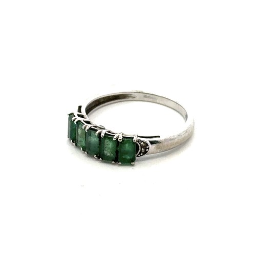 2 - A five stone emerald ring set in 9ct white gold with accent diamond shoulders. Size S.