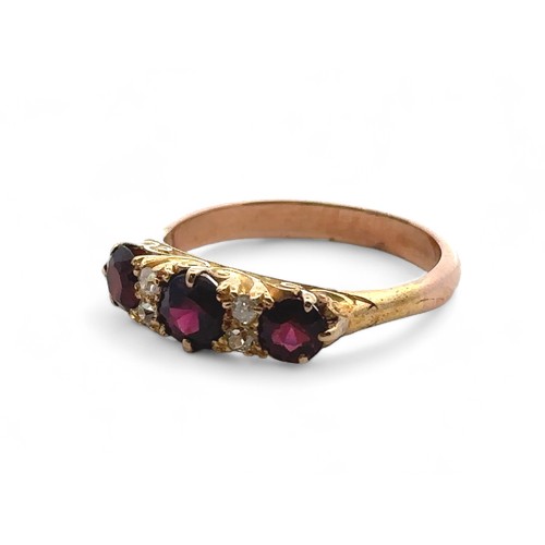 3 - A garnet and diamond ring, size S in a yellow gold scroll mount with a rose gold shank. 4.85g.