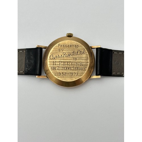 112 - A 9ct gold Roamer wrist watch with black leather strap. Inscribed to case back 'Presented by Carrs P... 