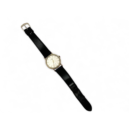 112 - A 9ct gold Roamer wrist watch with black leather strap. Inscribed to case back 'Presented by Carrs P... 