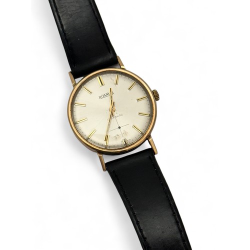 112 - A 9ct gold Roamer wrist watch with black leather strap. Inscribed to case back 'Presented by Carrs P... 