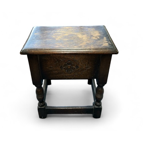 473 - Small standing oak sewing table in the form of a coffin stool, carved floral front, hinged lid, four... 