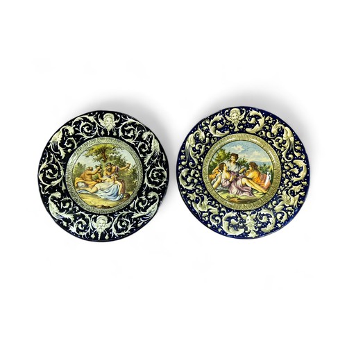 348 - A pair of 19th Century Italian Faience ware chargers, in the manner of Cantagalli, each with a mythi... 