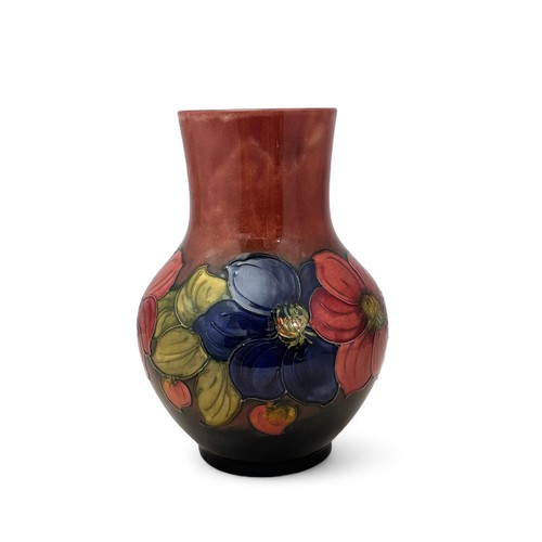 357 - A Moorcroft vase, bulbous shaped, in the flambe clematis pattern.  Height 25cm. Very small dink on o... 