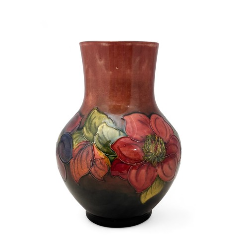 357 - A Moorcroft vase, bulbous shaped, in the flambe clematis pattern.  Height 25cm. Very small dink on o... 