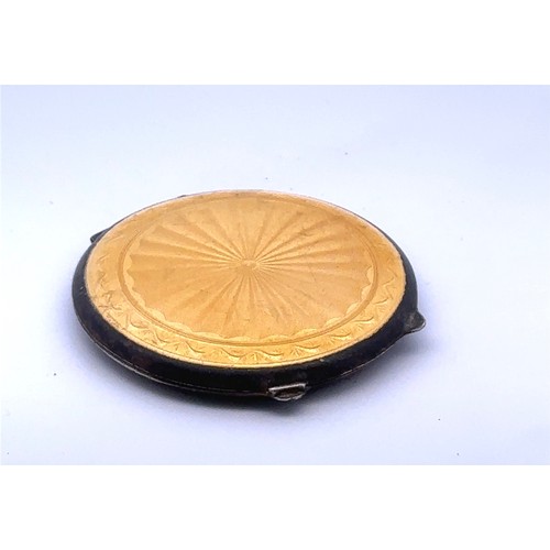 115 - A yellow guilloche enamel silver compact by Joseph Gloster, Birmingham 1946. Complete with powder pu... 