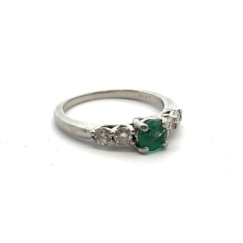 8 - An emerald and diamond ring, size I. Weight 3.35g. Marked as 950 platinum. Central emerald approx 4.... 