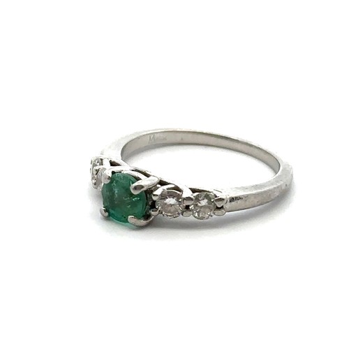 8 - An emerald and diamond ring, size I. Weight 3.35g. Marked as 950 platinum. Central emerald approx 4.... 