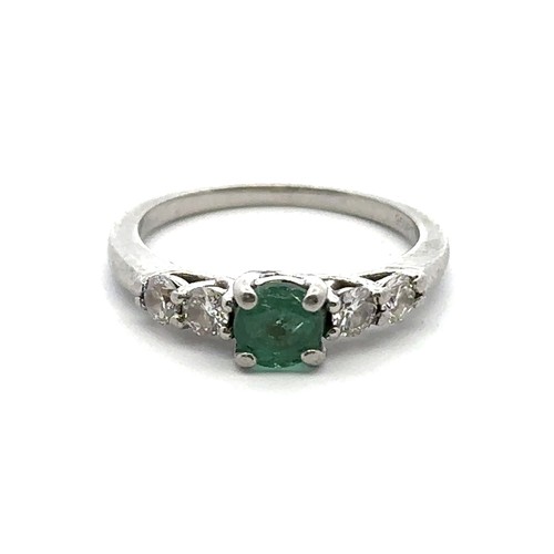 8 - An emerald and diamond ring, size I. Weight 3.35g. Marked as 950 platinum. Central emerald approx 4.... 