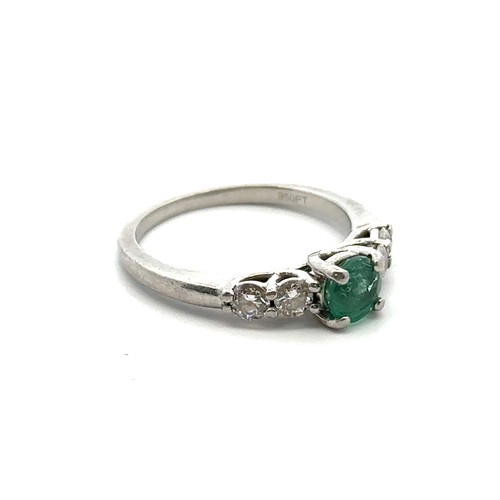 8 - An emerald and diamond ring, size I. Weight 3.35g. Marked as 950 platinum. Central emerald approx 4.... 