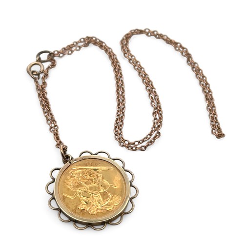 9 - A sovereign pendant necklace. A 1965 sovereign coin mounted in hallmarked 9ct gold on a chain stampe... 