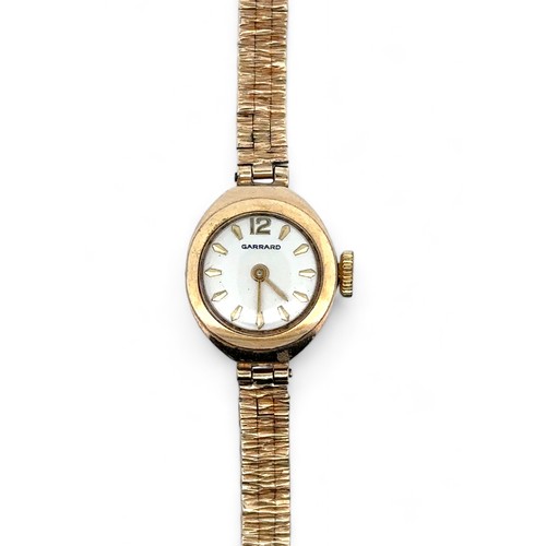 73 - A Garrard ladies 9ct gold watch with 9ct gold bracelet. Inscribed to back of case 'For Dunlop servic... 