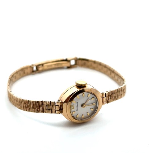 73 - A Garrard ladies 9ct gold watch with 9ct gold bracelet. Inscribed to back of case 'For Dunlop servic... 