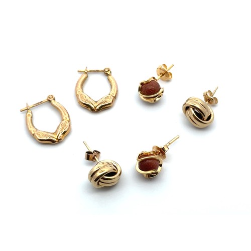 31 - 3 pairs of earrings. Includes a pair of hallmarked 9ct gold ram head hoop earrings, a pair of knot s... 