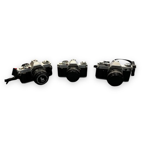 282 - Canon Cameras & Selection Of Lenses. Two Canon AV-1 bodies with attached 50mm f1.8 lenses. One AT-1 ... 