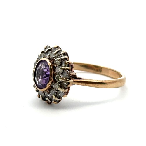 30 - An amethyst and diamond oval cluster ring, the amethyst with double border of diamonds, in a 9ct gol... 