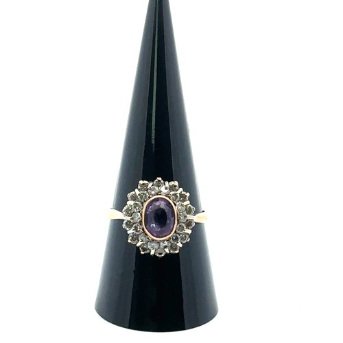 30 - An amethyst and diamond oval cluster ring, the amethyst with double border of diamonds, in a 9ct gol... 