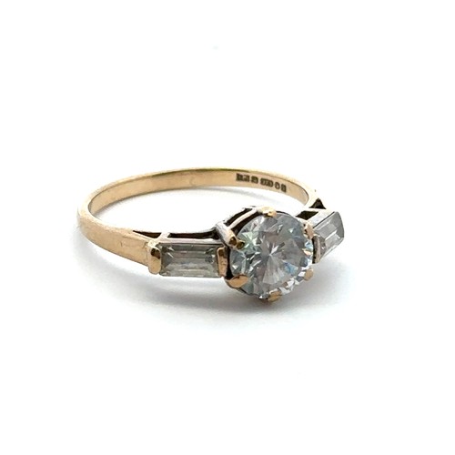 59 - A 9ct gold ring set with a central round cut CZ between two baguette cut CZs. Size N. Weight 2.12g