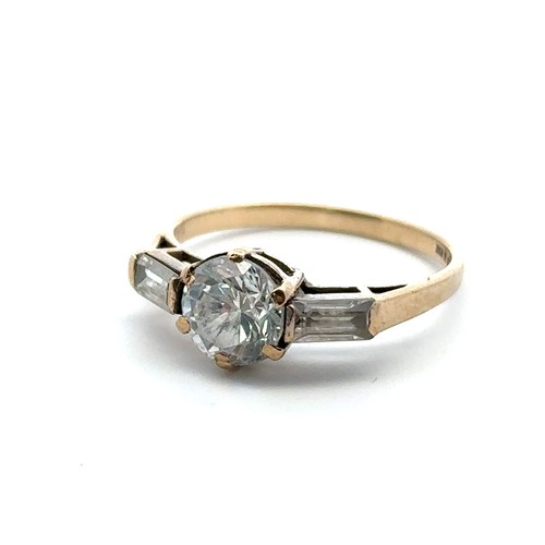 59 - A 9ct gold ring set with a central round cut CZ between two baguette cut CZs. Size N. Weight 2.12g