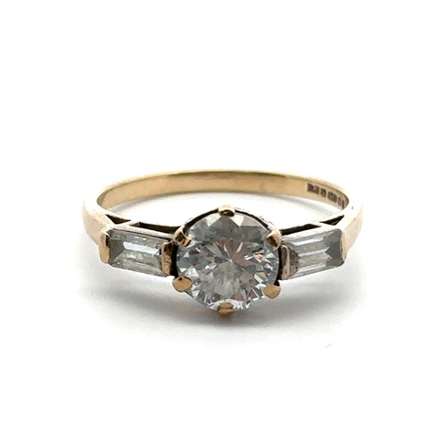 59 - A 9ct gold ring set with a central round cut CZ between two baguette cut CZs. Size N. Weight 2.12g