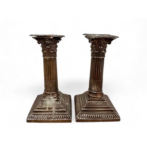 98 - A pair of Corinthian column design silver candlesticks on stepped square bases by William Hutton & S... 