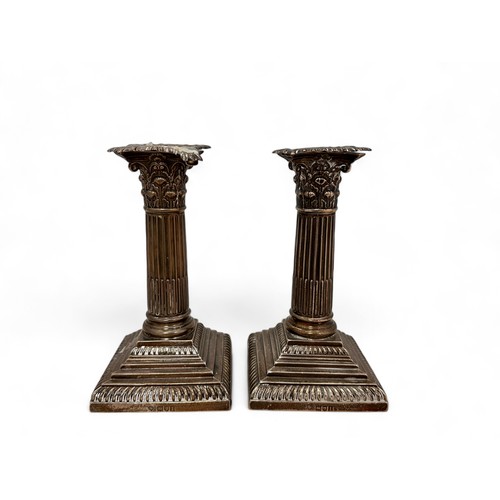 98 - A pair of Corinthian column design silver candlesticks on stepped square bases by William Hutton & S... 