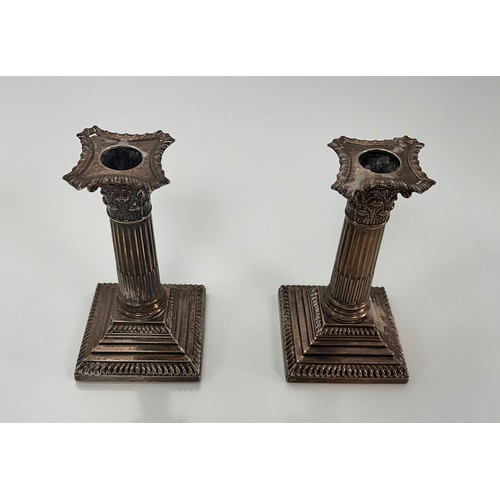 98 - A pair of Corinthian column design silver candlesticks on stepped square bases by William Hutton & S... 