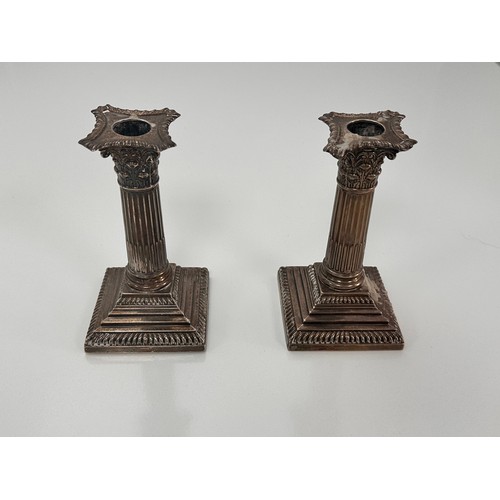 98 - A pair of Corinthian column design silver candlesticks on stepped square bases by William Hutton & S... 