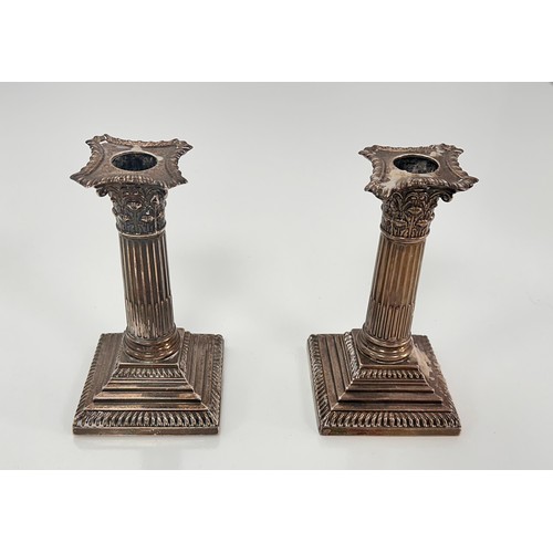 98 - A pair of Corinthian column design silver candlesticks on stepped square bases by William Hutton & S... 