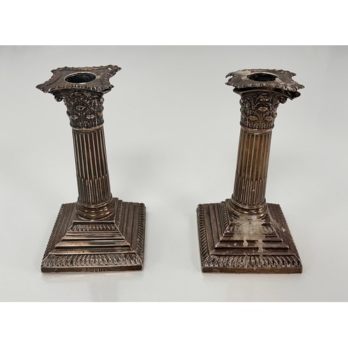 98 - A pair of Corinthian column design silver candlesticks on stepped square bases by William Hutton & S... 