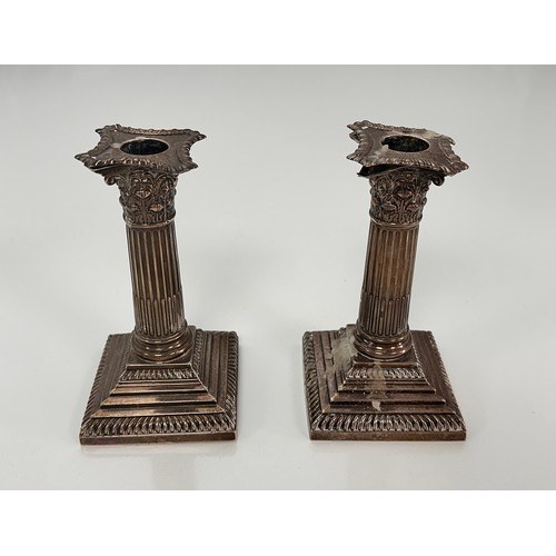 98 - A pair of Corinthian column design silver candlesticks on stepped square bases by William Hutton & S... 