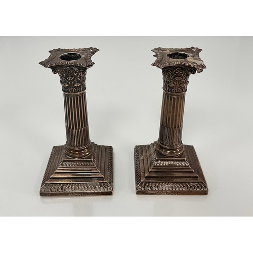 98 - A pair of Corinthian column design silver candlesticks on stepped square bases by William Hutton & S... 