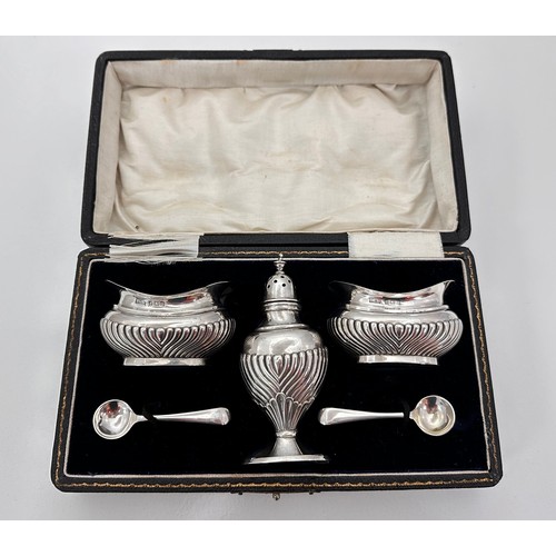 129 - A silver cruet set in a fitted case by T H Hazlewood & Co Birmingham 1908. 110g.