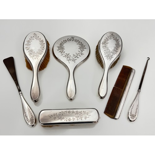 122 - A silver mounted dressing table set with attractive leaf and flower design. Includes a hand held mir... 