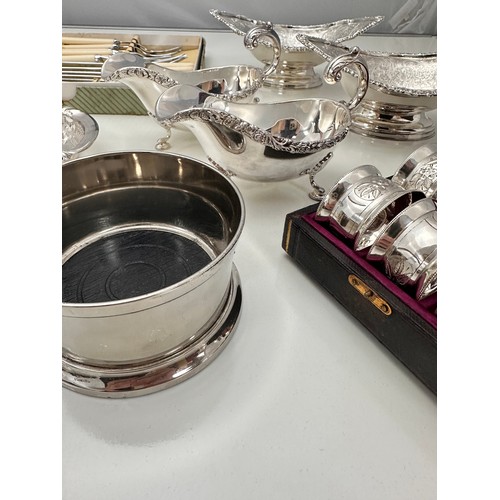 133 - A collection of good quality silver plated items. Includes a cased set of six silver plated napkin r... 