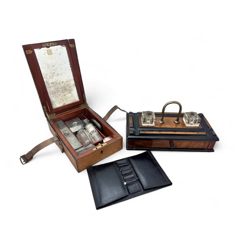 336 - An early 20th Century wooden ink stand with two glass inkwells, a drawer, a brass handle and on four... 