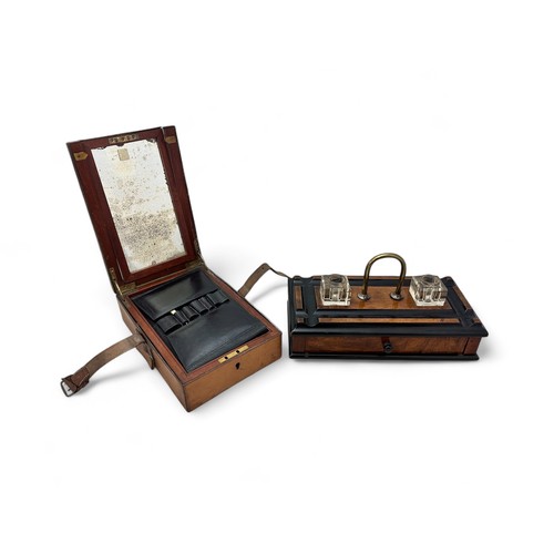 336 - An early 20th Century wooden ink stand with two glass inkwells, a drawer, a brass handle and on four... 