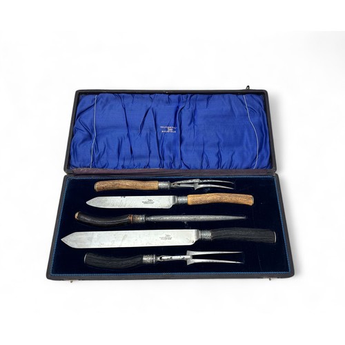 134 - A Walker & Hall horn handled carving set in a blue lined fitted case.