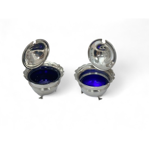 102 - A pair of silver salts with blue glass liners (mismatched).  Hallmarks for A & J Zimmerman Ltd, Birm... 